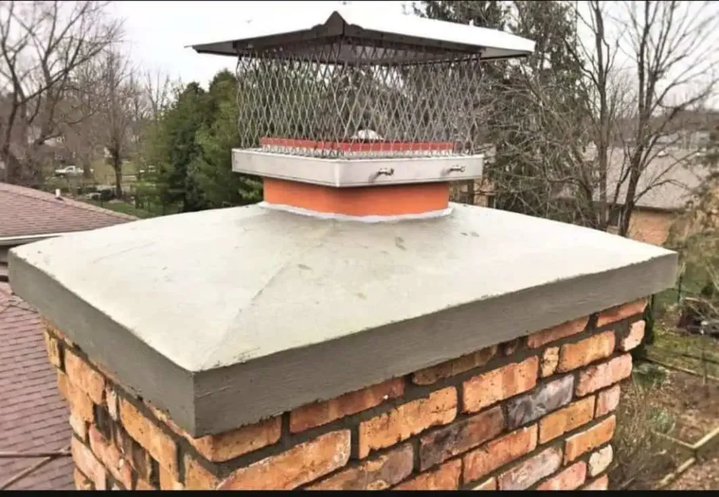 Chimney crown repair with metal cap installation on brick chimney in Indianapolis home