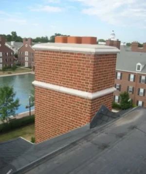 Brick chimney repair and installation in Indianapolis with proper crown and flashing on residential roof
