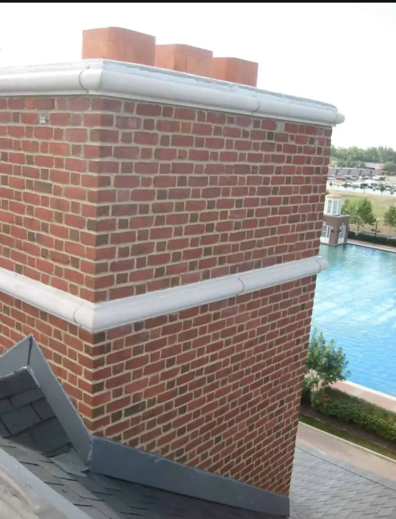 Comprehensive chimney repair and installation in Indianapolis featuring multiple clay flue pots and a custom concrete crown by Emerson Masonry Inc.