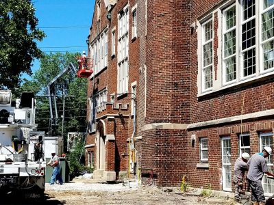 Emerson Masonry Inc. team performing tuckpointing and brick restoration on a historic building in Indianapolis.